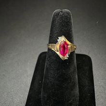 10k yellow gold ring w ruby stone in center & diamonds