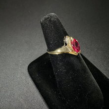 10k yellow gold ring w ruby stone in center & diamonds